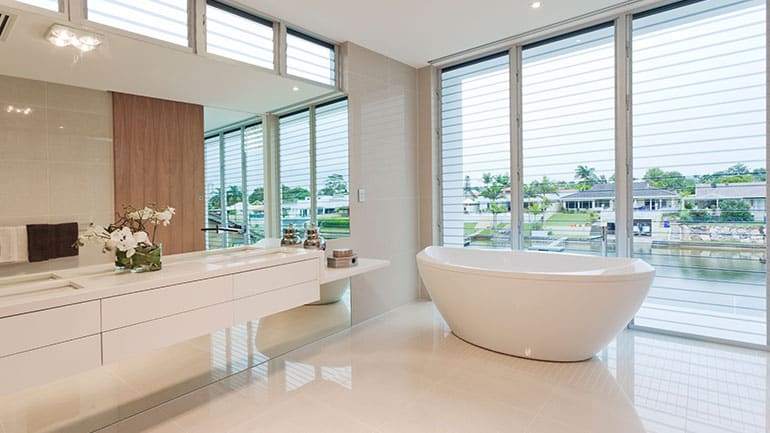 Vast open spaces with prominent bathtub overlooking a water view